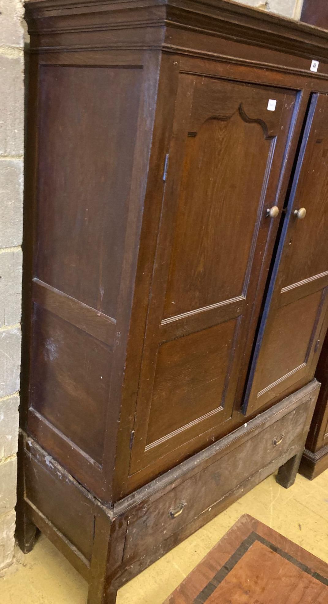 An 18th century oak press cupboard with base drawer, width 120cm height 169cm